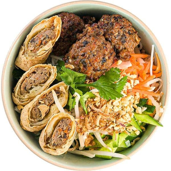 My Lai Kitchen's vermicelli bowl with crispy spring rolls, grilled pork patties, and fresh vegetables.